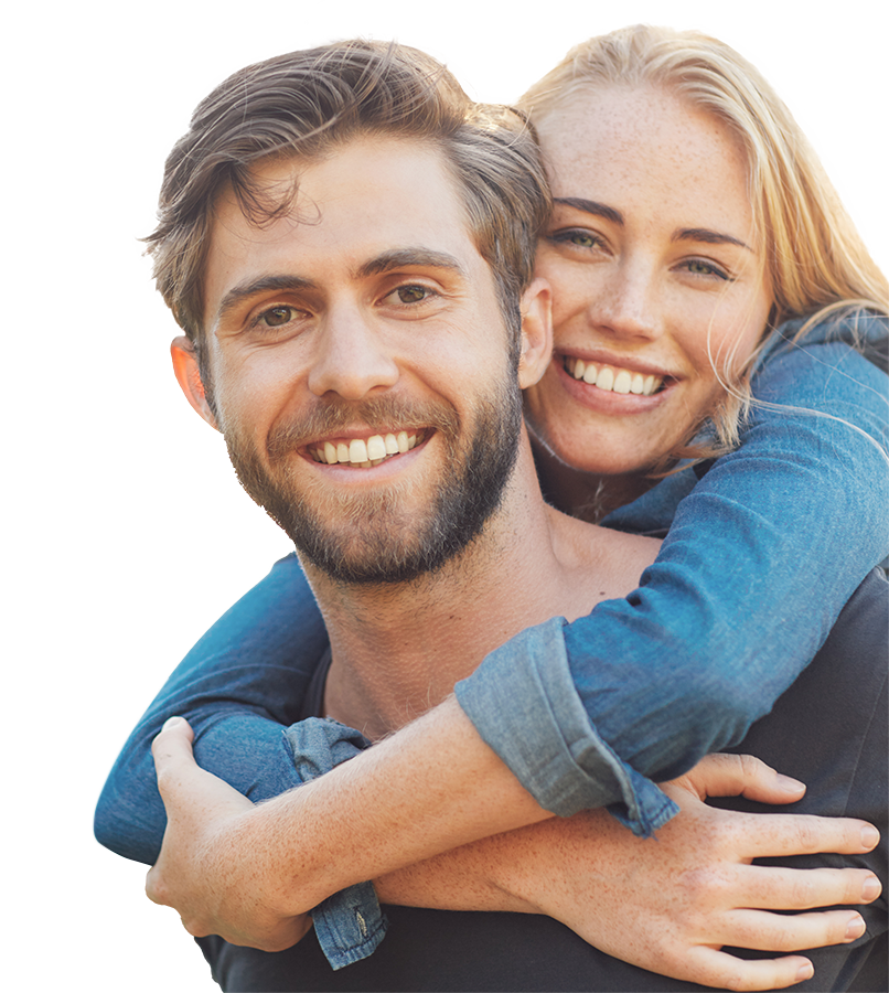 A man and woman smiling while looking at the camera.