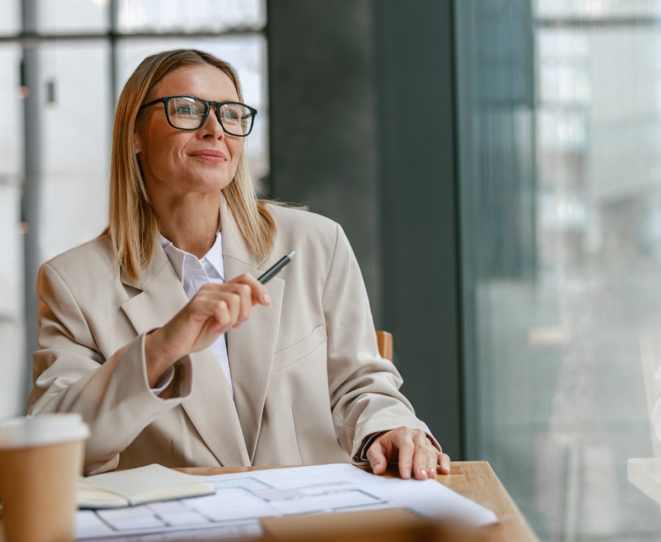 A business woman with building plans in front of her.